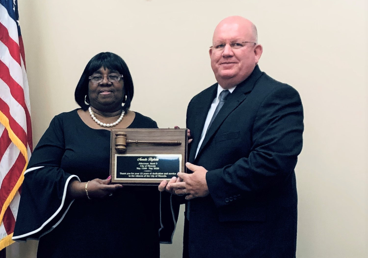 Mayor Kevin White presents Novada Bigham with a gavel in recognition of her 22 years of service to the Mineola City Council.